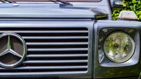 The Mercedes-Benz logo on the grille of a G-Class SUV.