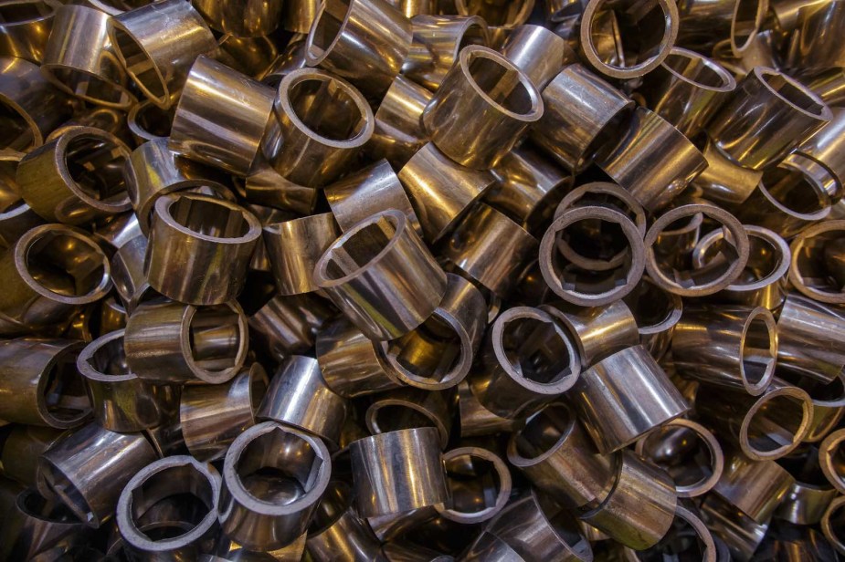 Dozens of round metal bushings jumbled together.