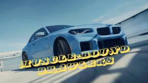 A blue 2024 BMW M2 slides sideways on a closed circuit.