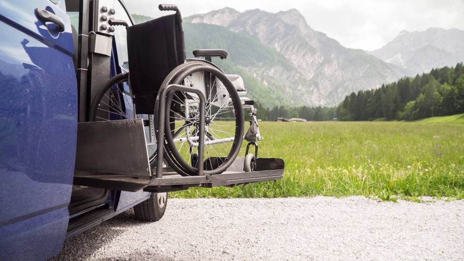 Wheelchair on a lift outside an adaptive van.