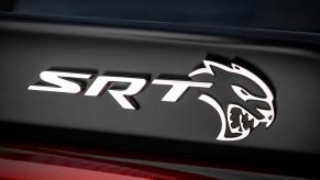 An SRT Hellcat badge on a Dodge performance car.