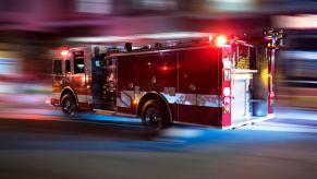 A fire engine speeds down a street while it holds an amount of water to fight fires.