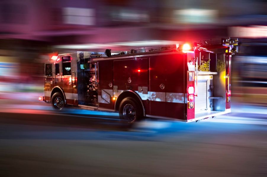 A fire engine speeds down a street while it holds an amount of water to fight fires.