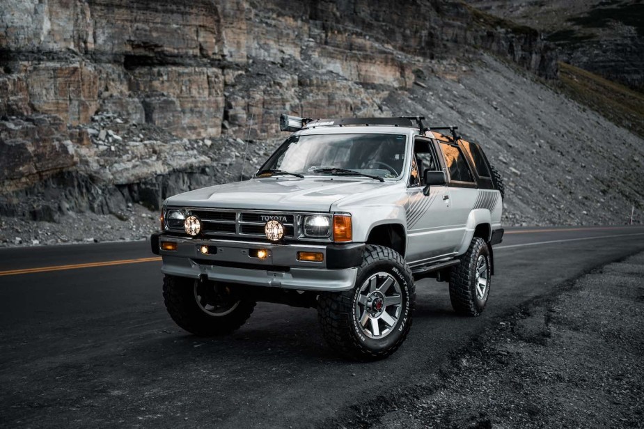 White first-gen Toyota 4Runner SUV off-roading