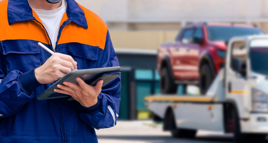 A car being repossessed due to auto loan delinquency