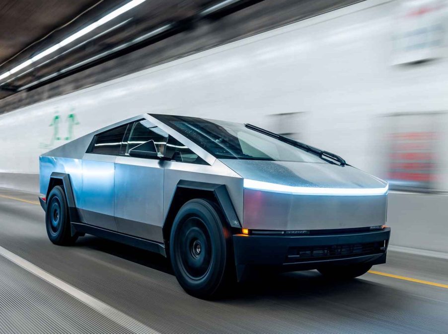 Tesla Cybertruck EV driving fast in a lighted tunnel