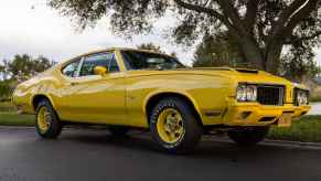 A 1970 Oldsmobile Cutlass Rallye 350 parked in lower right front side angle view