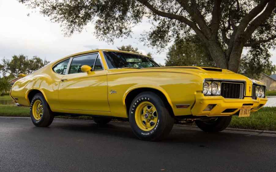 A 1970 Oldsmobile Cutlass Rallye 350 parked in lower right front side angle view