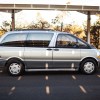 A silver 1994 Toyota Previa is parked in full right profile view