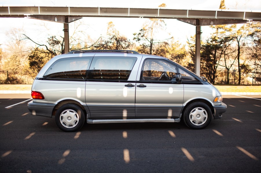 A silver 1994 Toyota Previa is parked in full right profile view