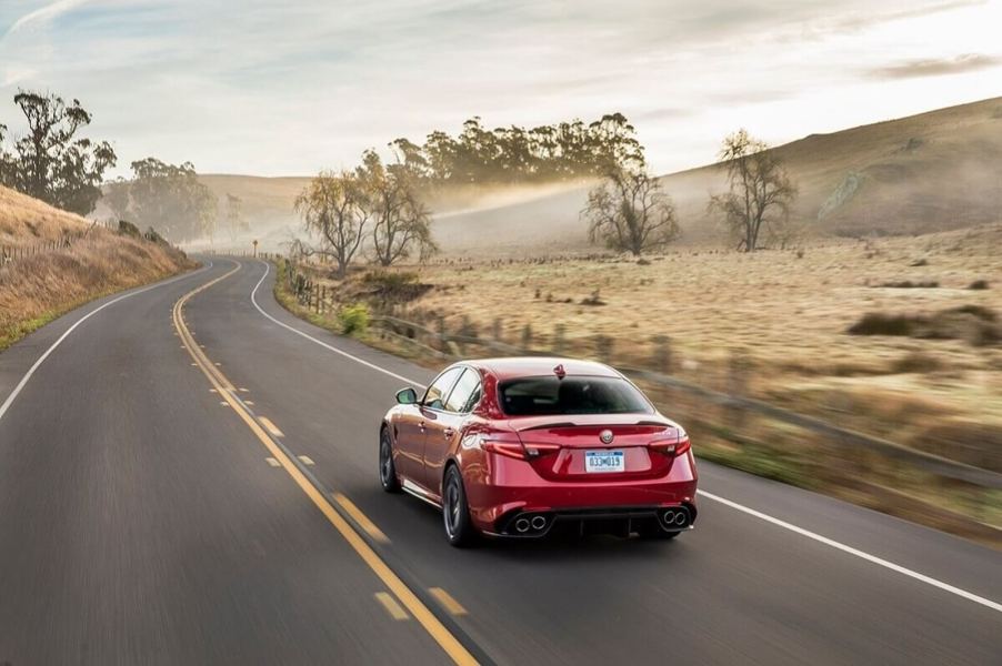 An Alfa Romeo Giulia Quadrifoglio drives across the desert.