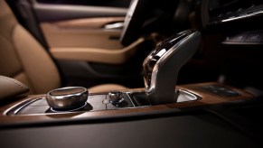 The wood and brown leather interior of a 2020 Cadillac CT5 sedan.