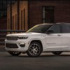 The 2024 Jeep Grand Cherokee parked near a home