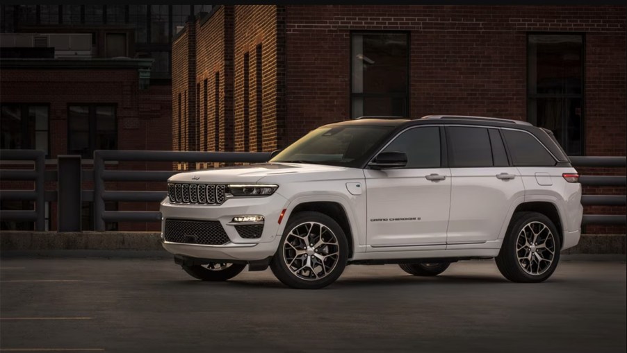 The 2024 Jeep Grand Cherokee parked near a home