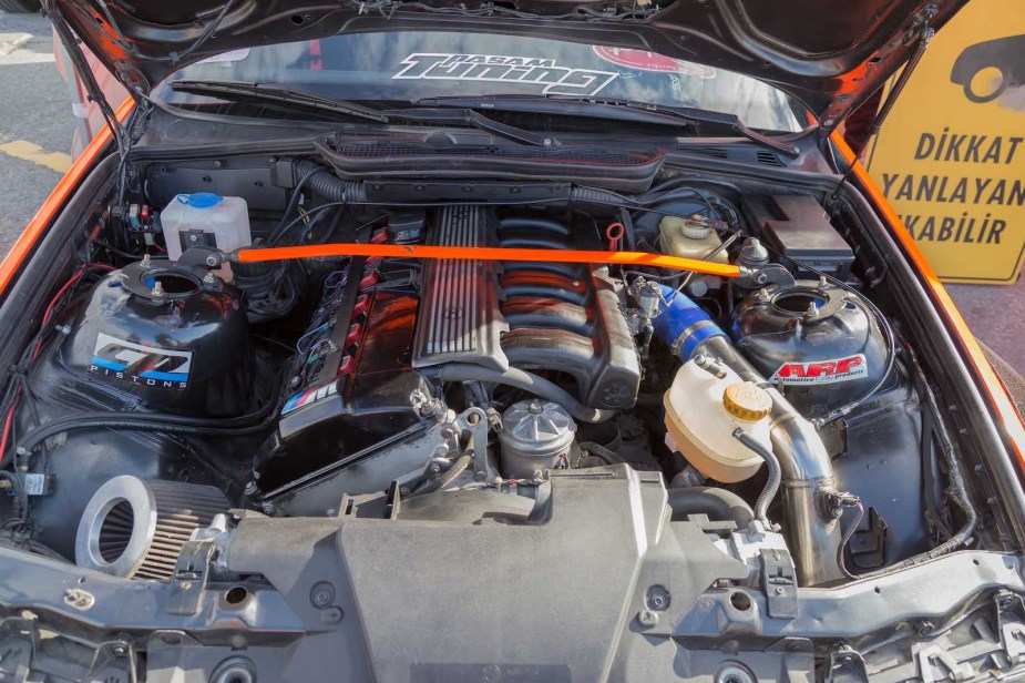 The engine bay of a BMW with its hood up.