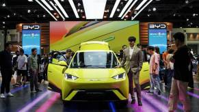 A yellow BYD Seagull, a cheap Chinese electric car grabs a crowd's attention.