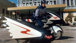 Adam West's Batman on the 1960s Batcycle sidecar motorcycle.