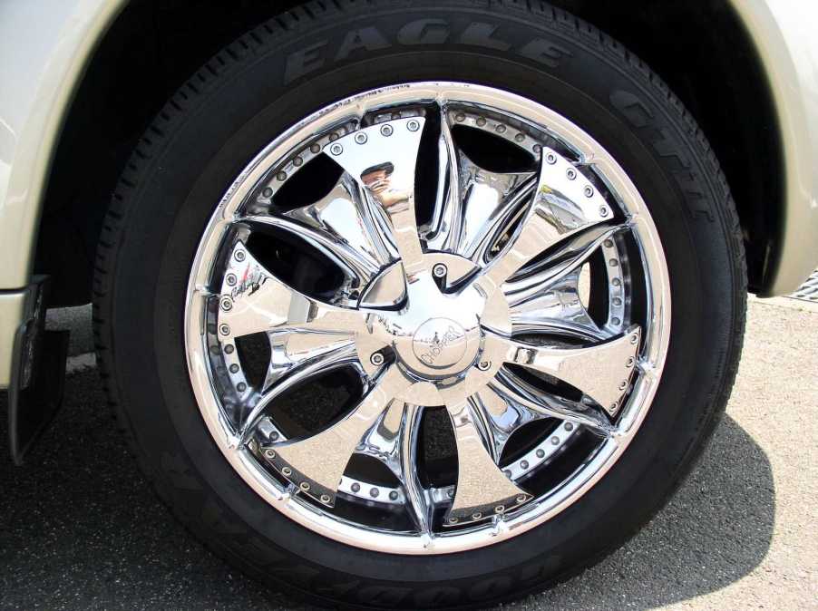 A custom car with chrome "spinner" or "floater" rims