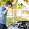 A driver calls for roadside assistance through their insurance provider.