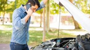 A driver calls for roadside assistance through their insurance provider.