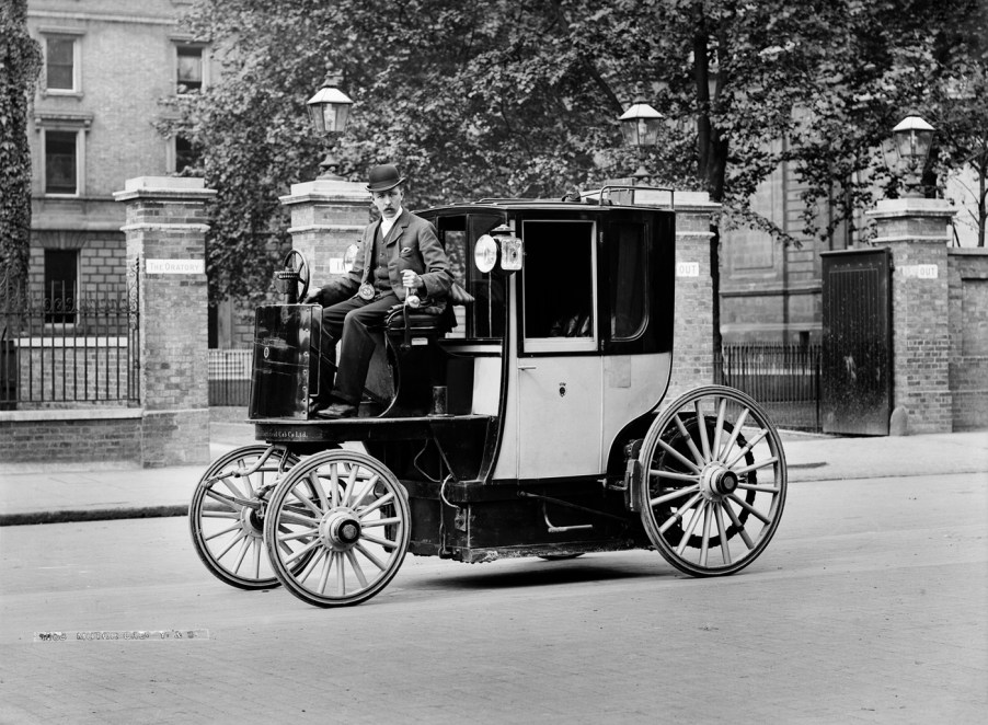 A man driving an electric car in 1897