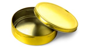 A golden colored empty metal tin with its top off, sitting on a white background.