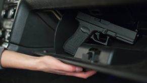 A truck owner reaches for a concealed gun in their glove compartment.