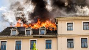 The roof of a house on fire.