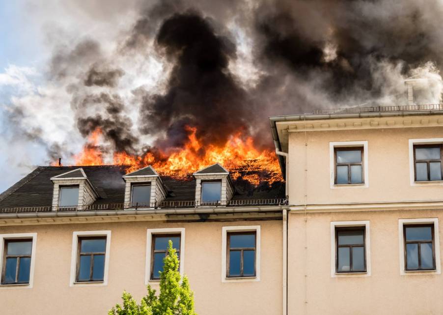 The roof of a house on fire.