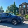 A blue 2024 Nissan Rogue crossover SUV in Louisville, Kentucky.