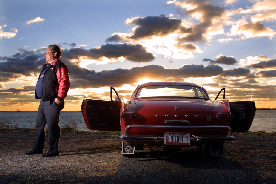 Irving Gordon stands next to his Guinness World Record holding Volvo P1800s