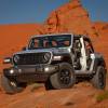 A silver Jeep Wrangler 4xe Willys has an estimated 22 miles of range in EV mode.