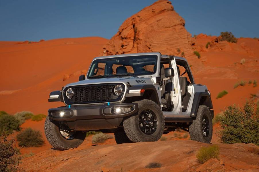 A silver Jeep Wrangler 4xe Willys has an estimated 22 miles of range in EV mode.