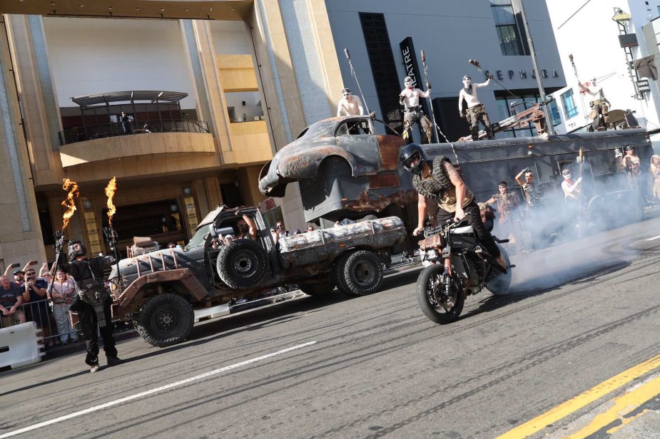 Stunt crew riding Mad Max vehicles through Hollywood during the Furiosa premiere.