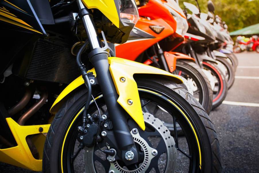 A series of motorcycles parking in a row.