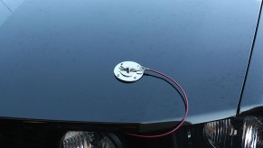 Chrome hood pins installed on a Mustang sports car