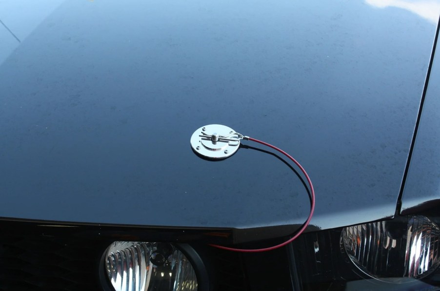 Chrome hood pins installed on a Mustang sports car