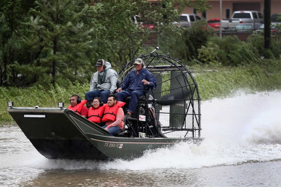 Texas authorities pilot an airboat through the flooded streets of Houston, Texas