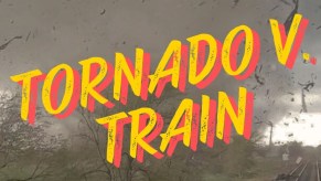 A video shows a tornado as it hits a train.