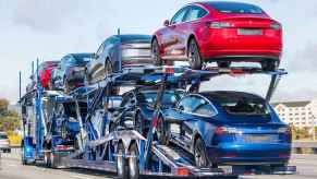 A fully stocked car transport truck carries eight Tesla sedans