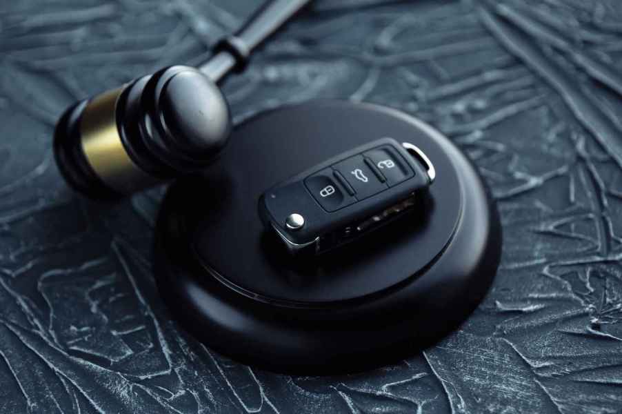 A court gavel shown with a car key fob