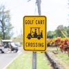 Bright yellow "Golf Cart Crossing" sign with a golf cart visible in the background.