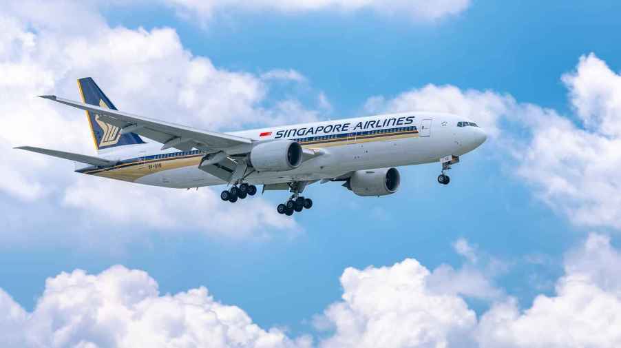 A Singapore Airlines plane flying mid-air with landing gear out