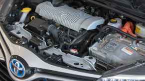 A Toyota hybrid vehicle's hood opened to show the engine, which is timing chain driven