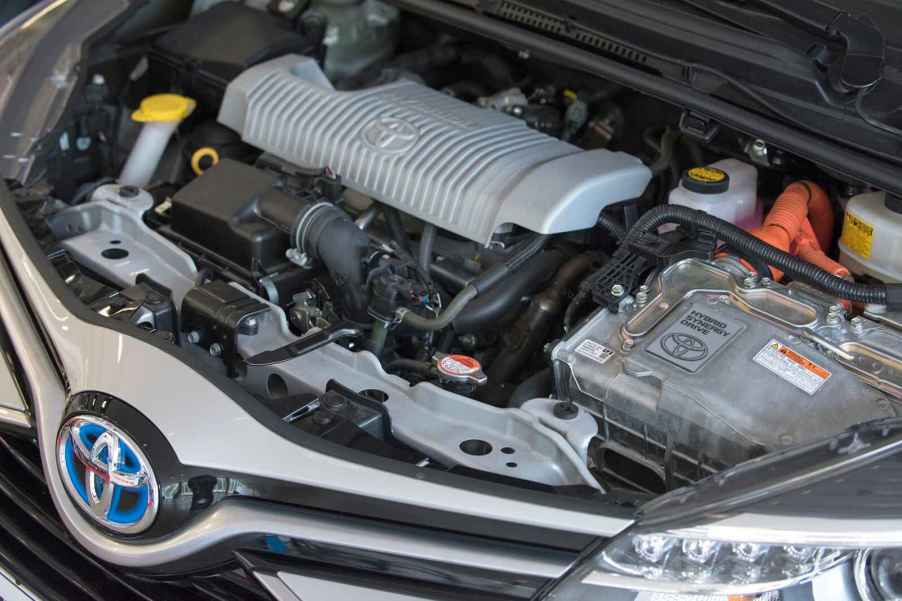 A Toyota hybrid vehicle's hood opened to show the engine, which is timing chain driven