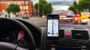 The view from a car with vent-mounted phone displaying Waze map app