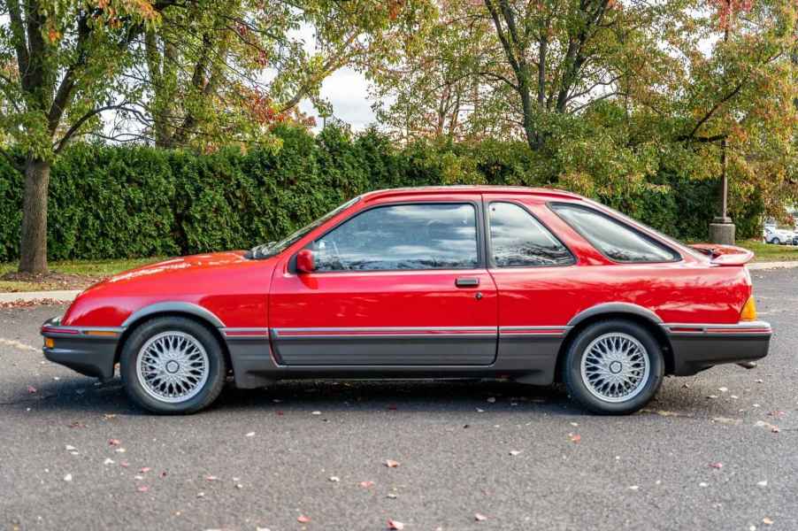 A red 1988 Merkur XR4Ti parked in full left profile view in a parking lot