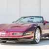 A maroon 1993 Chevrolet Corvette 40th Anniversary Edition parked with top off in left front angle view