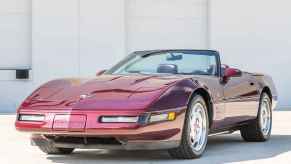 A maroon 1993 Chevrolet Corvette 40th Anniversary Edition parked with top off in left front angle view