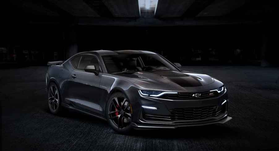 A dark grey 2024 Chevrolet Camaro coupe parked in a dark setting in right front angle view, the Camaro will be discontinued after 2024